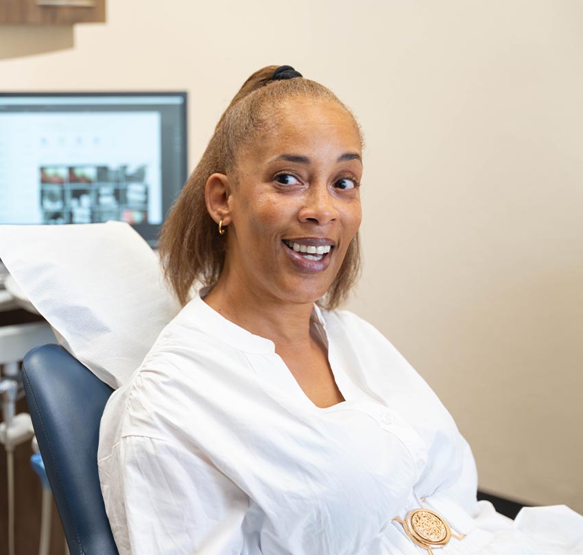 a seated female patient inside the clinic of Waldman Dental Group